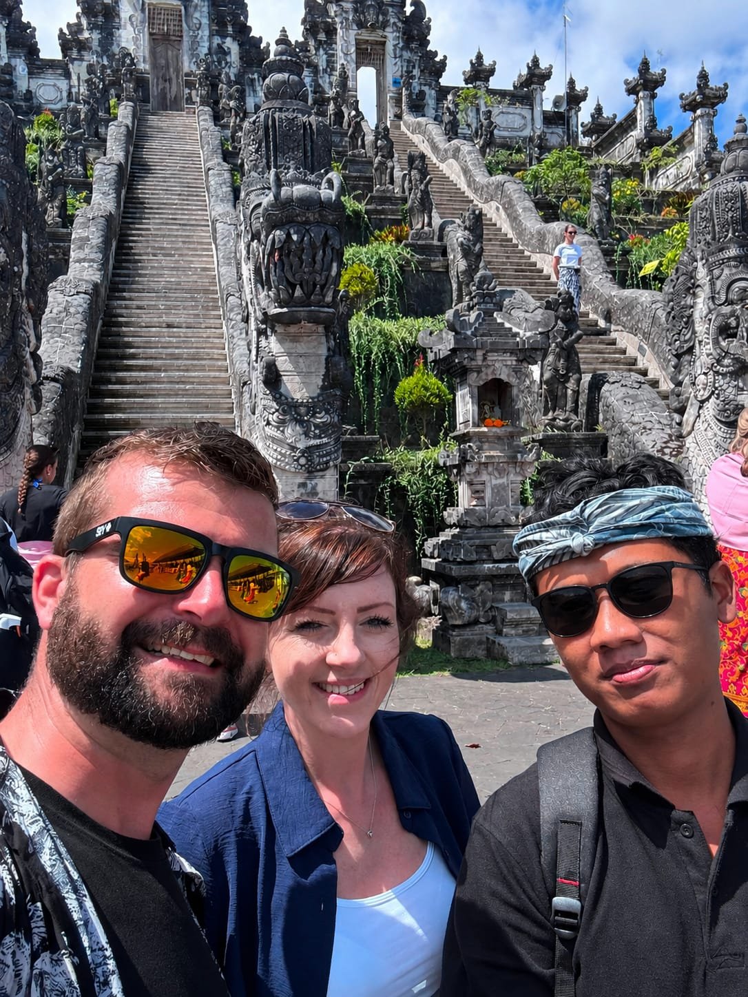 Local Bali driver with guests at a waterfall viewpoint